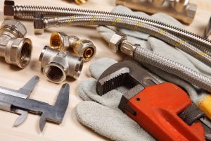 Set of plumbing and tools on the table.